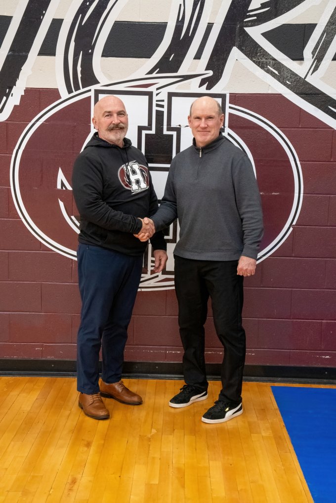 Pictured above are Left, Albert Roache, Director, Athletics and Recreation at Holland College and right, Mike Connolly, PEISAA School Sport Coordinator sealing the agreement at the Holland College gym. 